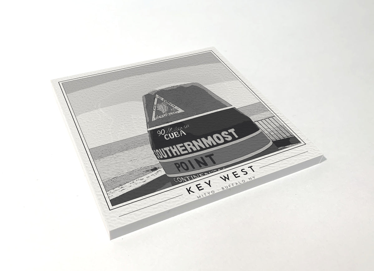 Square poster-style coaster of the striped Southernmost Point buoy in Key West, black-and-white