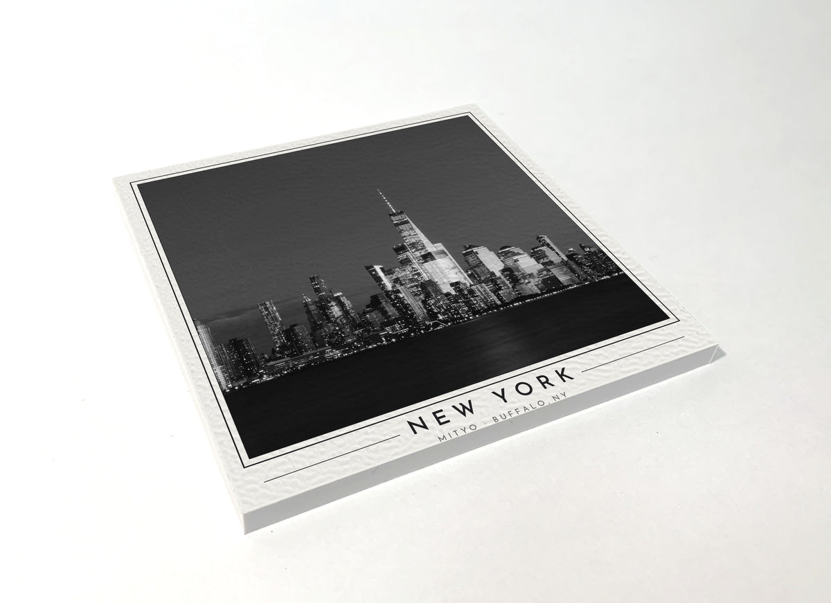 Square poster-style coaster of the Lower Manhattan skyline at night, black-and-white