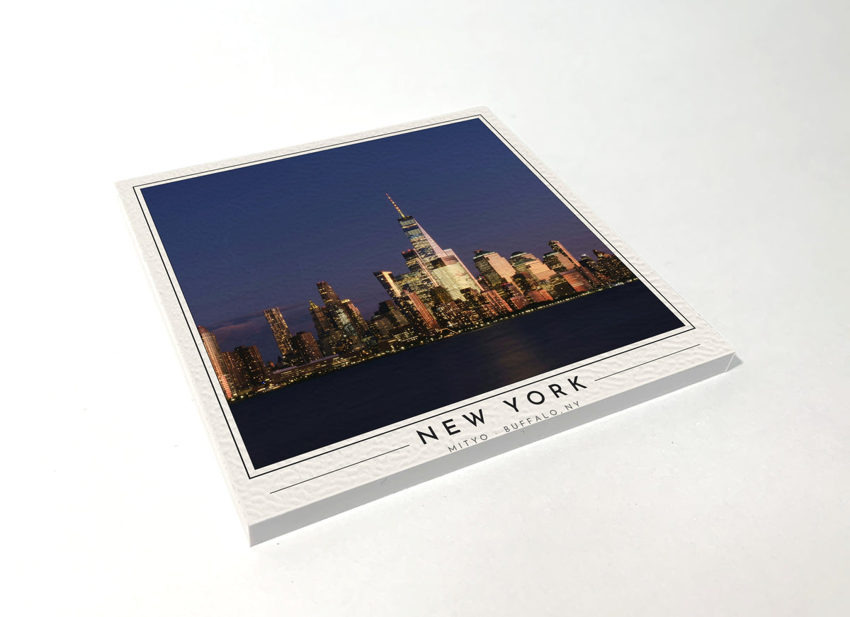 Square poster-style coaster of the Lower Manhattan skyline at night, full-color