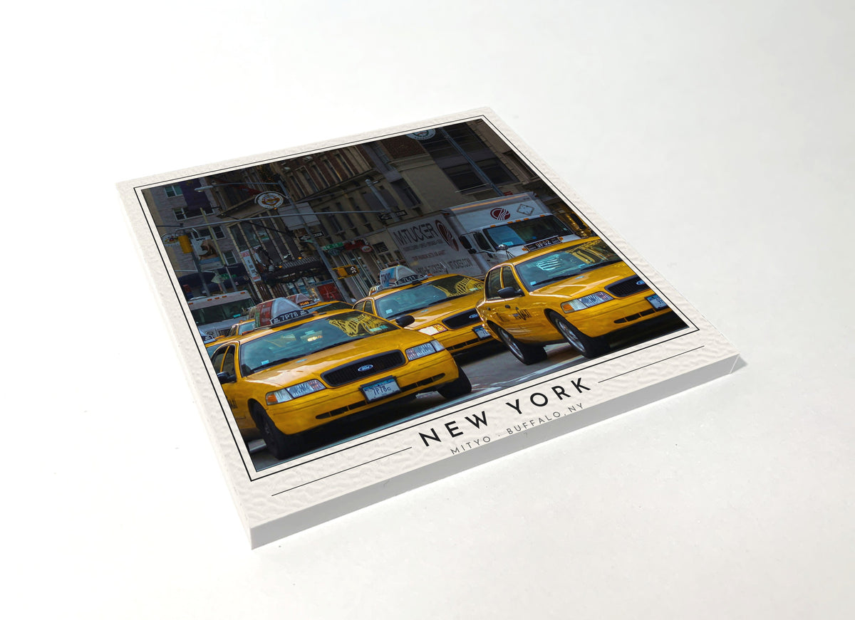 Square poster-style coaster of a line of yellow NYC taxi cabs, full-color